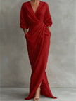 FJØRNA white V neck wrap waist long sleeve maxi dress displayed on a hanger, showcasing its elegant design and flowing fabric.