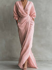 FJØRNA white V-neck wrap waist long sleeve maxi dress displayed on a hanger, showcasing its elegant design and flowing fabric.