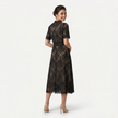 FJØRNA women's elegant lace midi dress with high neckline and refined cutwork detail, showcasing a sophisticated silhouette.