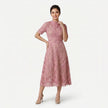 Women's elegant lace midi dress by FJØRNA featuring a high neck silhouette and intricate cutwork detail.
