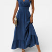 Women's sleeveless maxi dress by FJØRNA featuring a flowy fit and timeless style, shown hanging on a hanger.