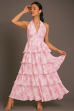 Pink FJØRNA halter floral tiered ruffle maxi dress with waist detail, featuring a flowing design and vibrant floral print.