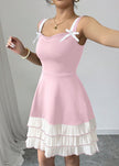 Pink FJØRNA summer party dress featuring a mini length, bow detail, and ruffled design perfect for festive occasions.