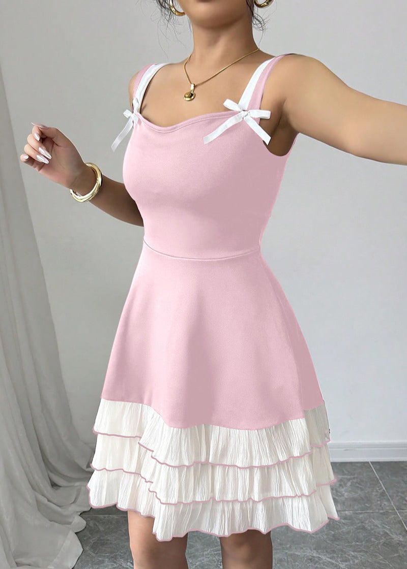 Pink FJØRNA summer party dress featuring a mini length, bow detail, and ruffled design perfect for festive occasions.