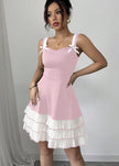 Pink mini summer party dress by FJØRNA, side view showing lightweight fabric and stylish sleeveless design.