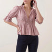 Pink V-neck puff sleeve lace blouse for women by FJØRNA, stylish summer top with feminine details and delicate lace fabric.