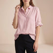 Pink denim ruffle summer blouse for women by FJØRNA, casual top with feminine details and relaxed fit.