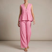 Pink FJØRNA summer two-piece women's co-ord set with wide-leg pants and V-neck top, styled for warm weather.
