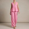 Pink FJØRNA summer two-piece women's co-ord set with wide-leg pants and V-neck top, styled for warm weather.