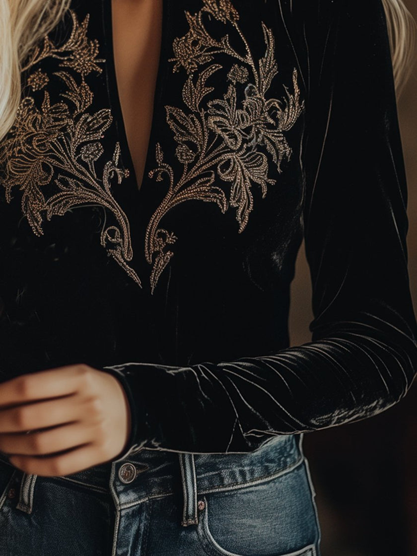 Black V-neck embroidered velvet long sleeve top by FJØRNA, featuring elegant embroidery and soft velvet fabric.