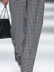 White houndstooth tailored women's straight-leg trousers from FJØRNA, shown flat with detailed fabric close-up.