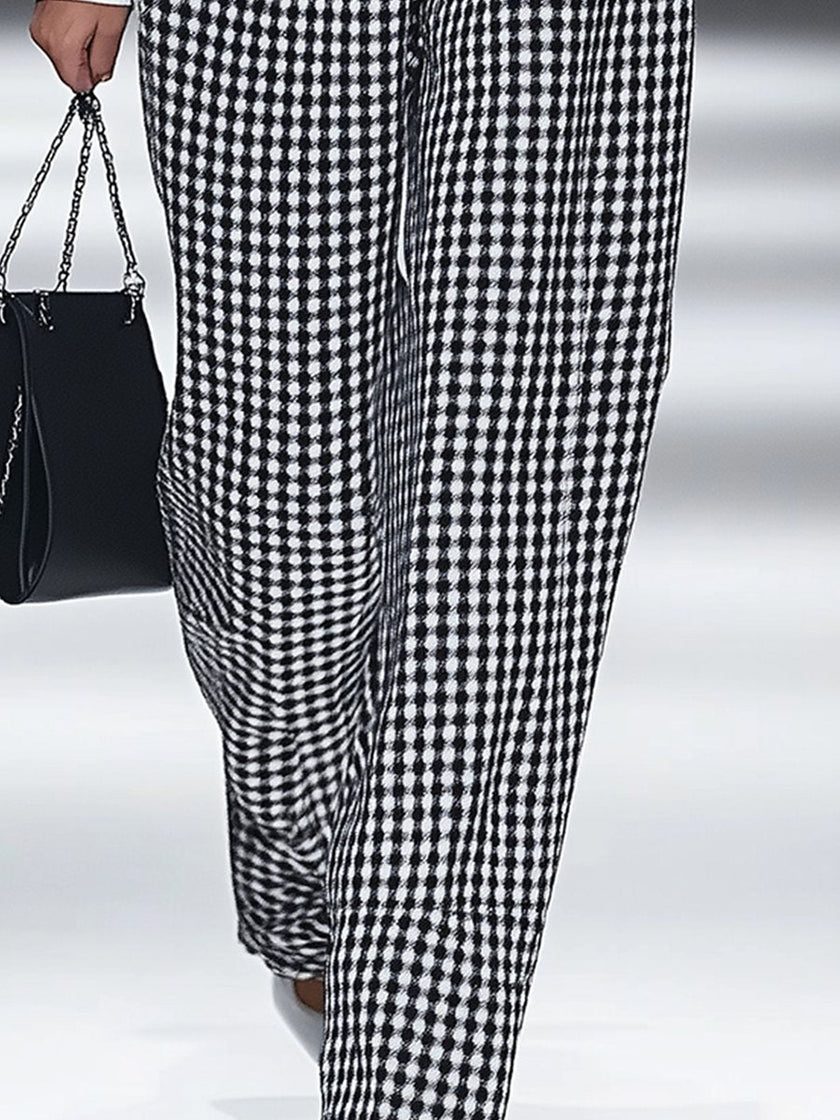 White houndstooth tailored women's straight-leg trousers from FJØRNA, shown flat with detailed fabric close-up.
