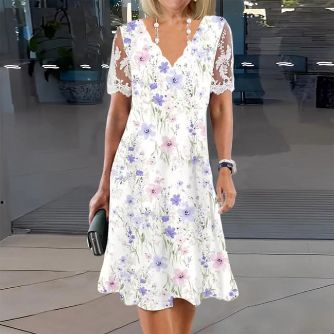 FJØRNA elegant floral midi dress for women with V-neck, flowing fabric, and stylish design perfect for casual or semi-formal wear.