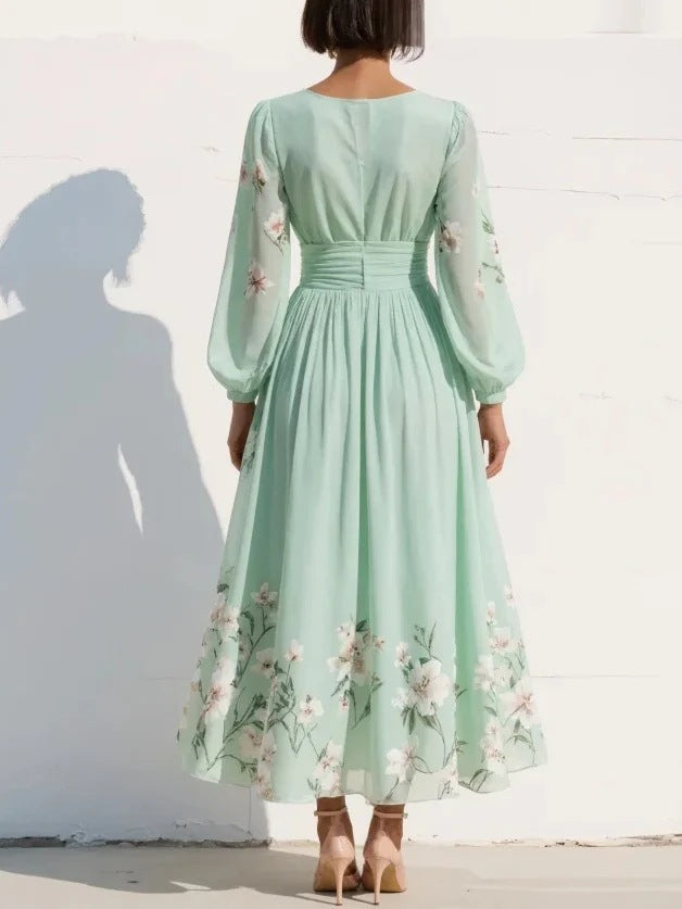 FJØRNA floral print long-sleeved V-neck pleated dress with elegant design and vibrant flower patterns on lightweight fabric
