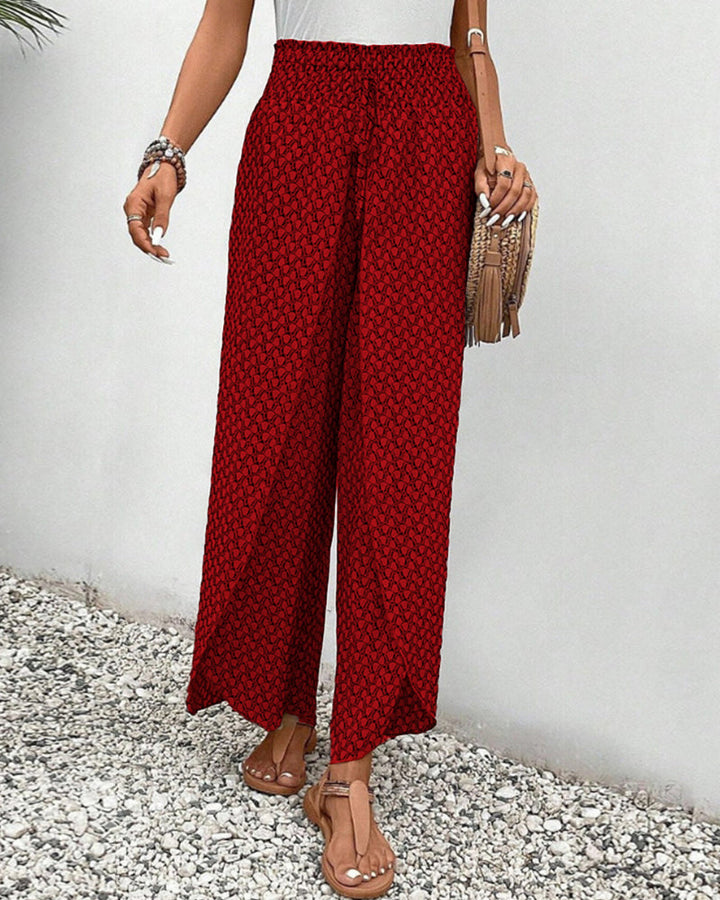 Red FJØRNA women's lightweight summer trousers with wide leg, breathable and flowy fabric, perfect for warm weather.