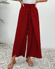 Red FJØRNA lightweight summer women's wide-leg trousers, breathable and flowy for warm weather.