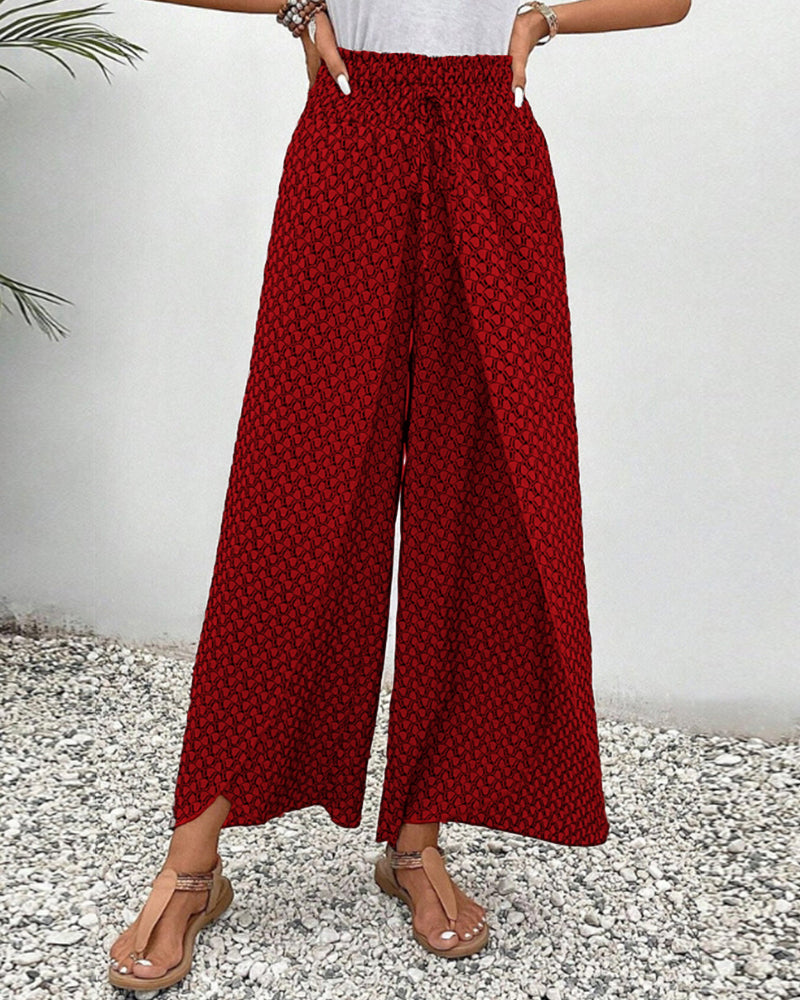 Red FJØRNA lightweight summer women's wide-leg trousers, breathable and flowy for warm weather.