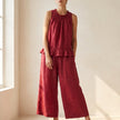 Red FJØRNA two-piece women's co-ord set with ruffle high neck top and matching pants, stylish and elegant for any occasion.
