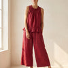 Red FJØRNA two-piece women's co-ord set with ruffle high neck top and matching pants, stylish and elegant for any occasion.