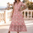Red FJØRNA ruffled hem A-line maxi dress for women, flowing fabric with a flattering silhouette and elegant design.