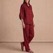 Red woven two-piece relax shirt and wide-leg trouser set by FJØRNA, ideal for urban leisure and comfortable styling.