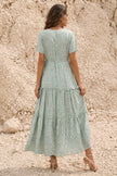 FJØRNA sage green floral print dress with long sleeves and a flowing silhouette, perfect for spring or summer occasions.