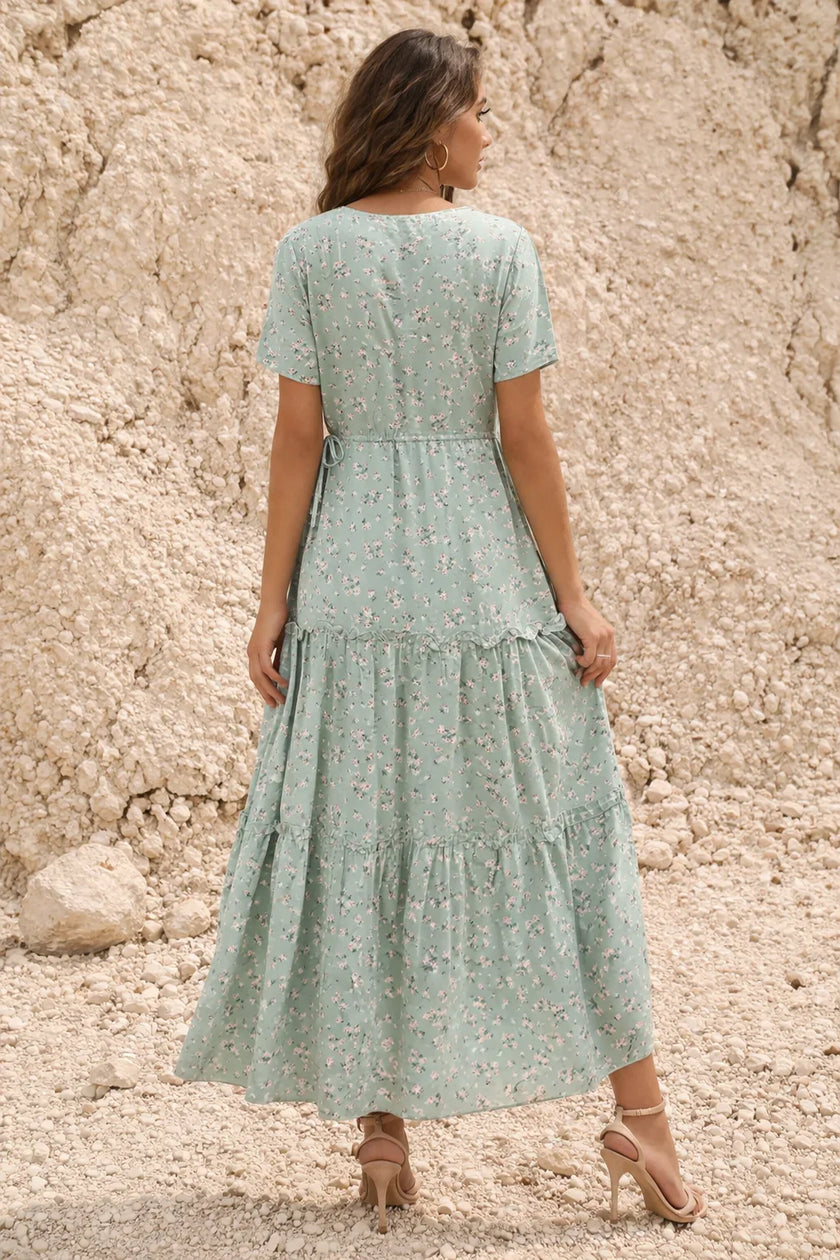 FJØRNA sage green floral print dress with long sleeves and a flowing silhouette, perfect for spring or summer occasions.