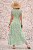 Sage green asymmetric dress by FJØRNA featuring a flowing silhouette and elegant drape, perfect for stylish occasions.
