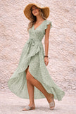 Sage green FJØRNA asymmetric dress with flowing fabric and elegant drape, showcasing a stylish, modern design.