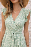 Sage green asymmetric dress by FJØRNA with flowing fabric and unique hemline, perfect for stylish occasions.