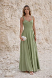 Sage green FJØRNA wedding guest dress with elegant flowing fabric, long sleeves, and a classic style perfect for special occasions.