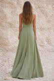 Sage green FJØRNA wedding guest dress with elegant flowy fabric and stylish design, perfect for special occasions.