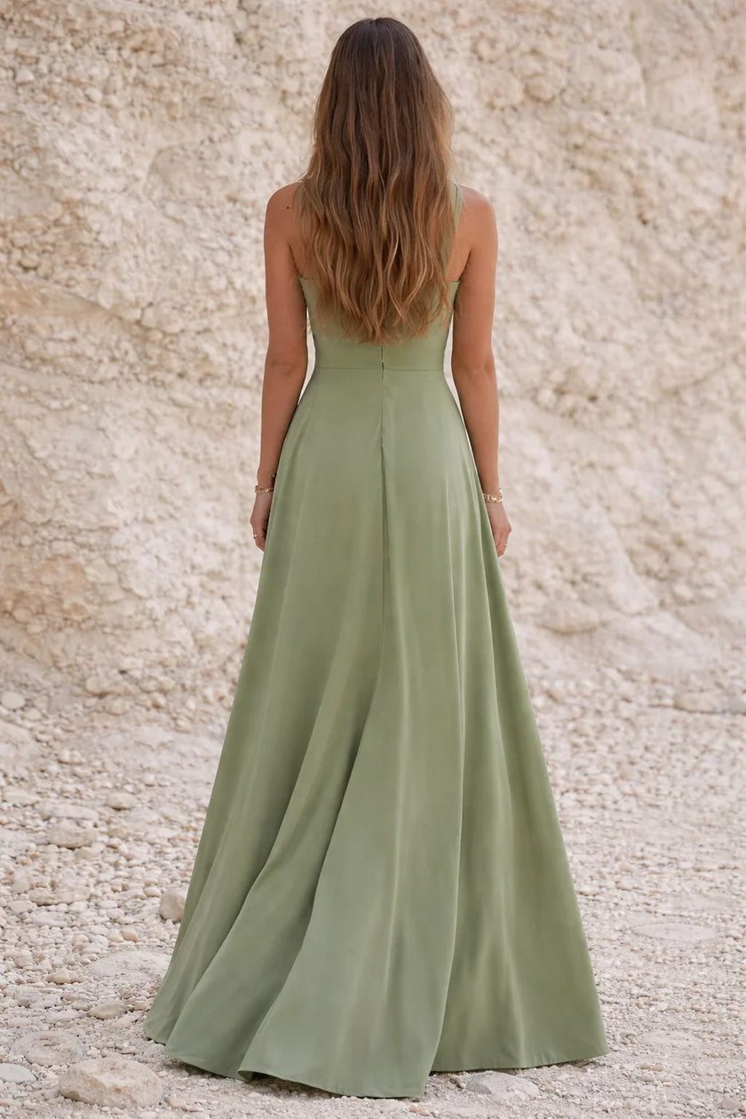 Sage green FJØRNA wedding guest dress with elegant flowy fabric and stylish design, perfect for special occasions.