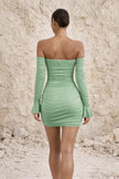 Sage green FJØRNA cocktail dress with elegant fit-and-flare design, featuring a sleeveless top and flowing skirt.