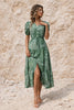 Sage green FJØRNA flowy dress with lightweight fabric, long sleeves, and a relaxed, elegant silhouette.