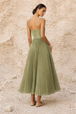 Sage green FJØRNA pleated midi dress with long flowing sleeves and a relaxed, elegant silhouette.