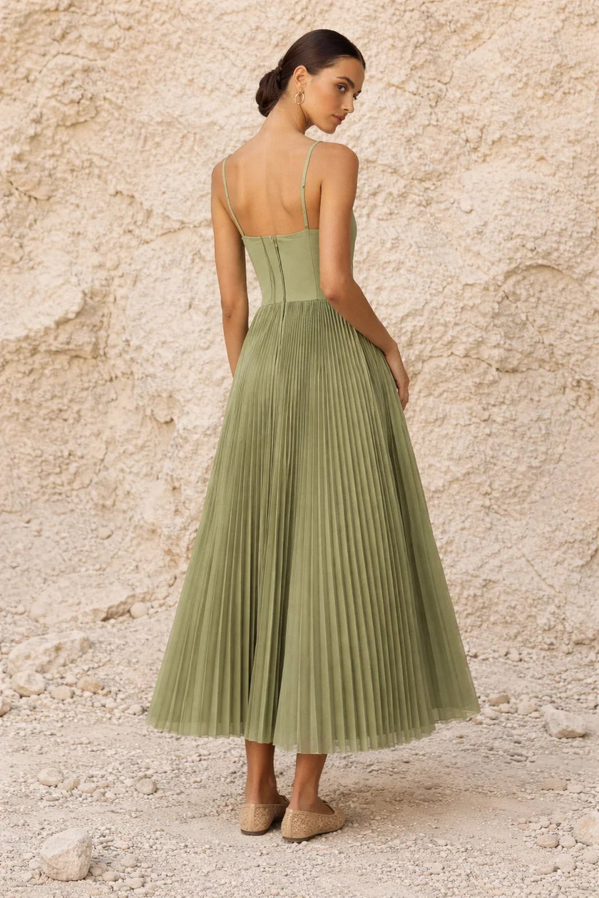 Sage green FJØRNA pleated midi dress with long flowing sleeves and a relaxed, elegant silhouette.