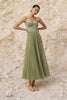 Sage green pleated midi dress from FJØRNA featuring a flowing silhouette and elegant pleats.