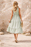 Sage green striped midi dress by FJØRNA featuring a flowing silhouette and stylish vertical stripes.