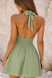 FJØRNA sage green short skater dress with fitted bodice and flared skirt, perfect for casual or semi-formal occasions.