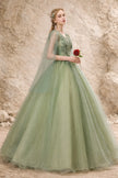 Sage green tulle wedding guest dress by FJØRNA featuring a flowing, elegant design perfect for special occasions.