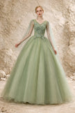 Sage green tulle wedding guest dress by FJØRNA, featuring a flowing silhouette and delicate fabric for elegant occasion wear.