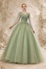 Sage green tulle wedding guest dress by FJØRNA, featuring a flowing silhouette and delicate fabric for elegant occasion wear.