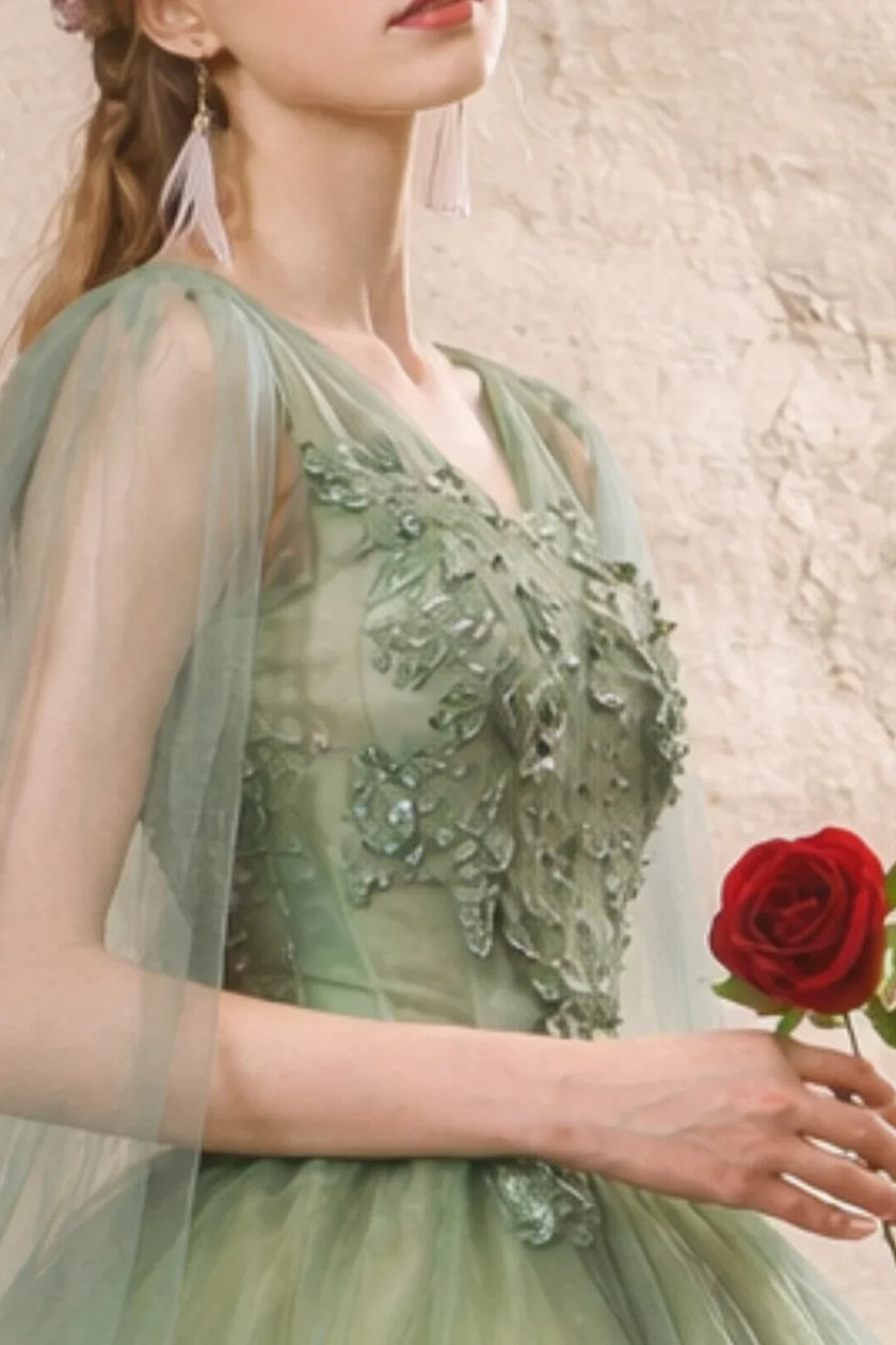 Sage green tulle wedding guest dress by FJØRNA, featuring a flowy, elegant design with layered tulle fabric.
