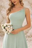 Sage green FJØRNA bridesmaid dress, elegant floor-length gown with flowy fabric and sleeveless design, perfect for weddings.