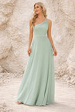 Sage green bridesmaid dress by FJØRNA featuring a flowing gown with elegant fabric and a fitted bodice.