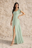 Sage green plus size dress with slit by FJØRNA, featuring flowing fabric and stylish design, perfect for elegant occasions.