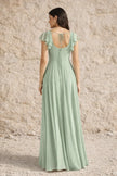 Sage green plus size FJØRNA dress with a slit, flowing fabric, and elegant design for a stylish look.