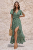 Dark sage green FJØRNA dress with long sleeves and a flowing silhouette, shown on a hanger against a neutral background.