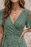 Dark sage green FJØRNA dress with long sleeves and a flowing silhouette, perfect for casual or semi-formal occasions.